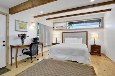 a bedroom with a bed and a desk and a computer at Overlook Hotel in Saugerties