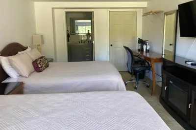 a hotel room with two beds and a desk and a computer at Overlook Hotel in Saugerties