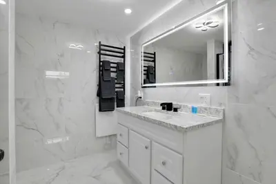 a white bathroom with a sink and a mirror at Overlook Hotel in Saugerties