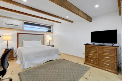 a bedroom with a bed and a flat screen tv at Overlook Hotel in Saugerties