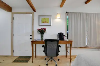 a bedroom with a desk and a chair and a door at Overlook Hotel in Saugerties