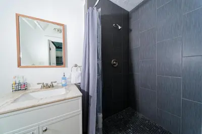 a bathroom with a sink and a shower at Croton Nook - Cozy Getaway in Croton-on-Hudson