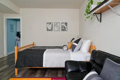 a bedroom with a bed and a couch at Croton Nook - Cozy Getaway in Croton-on-Hudson