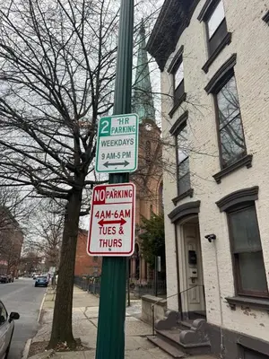 a green pole with street signs on it at Luxury Downtown w Backyard in Troy