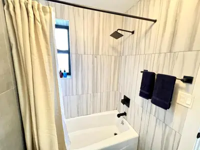 a bathroom with a sink and a toilet and a shower at Madison Ave Oasis in New York