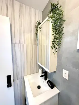 a bathroom with a sink and a mirror at Madison Ave Oasis in New York