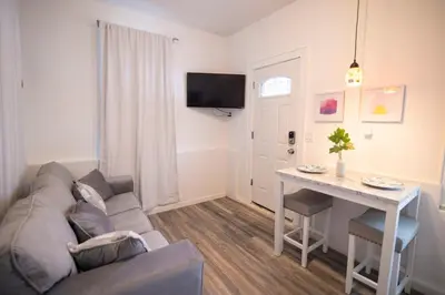 a living room with a couch and a table at Lovely 1 bedroom apt with patio by Yankee Stadium in Melrose