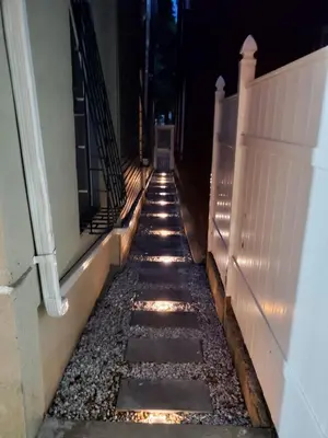 a walkway with rocks on the side of a building at Lovely 1 bedroom apt with patio by Yankee Stadium in Melrose