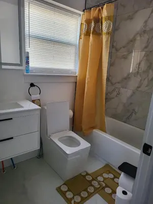 a bathroom with a toilet and a sink at Tkc Villa in Newark