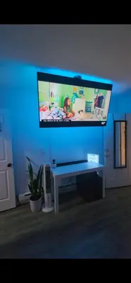 a large television in a living room with a blue light at The Eternal Oasis in Newark