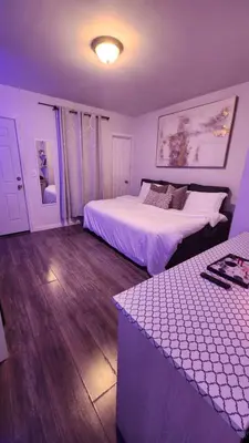 a bedroom with two beds and a table in it at The Eternal Oasis in Newark
