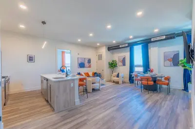 a living room with a kitchen and a living room with furniture at Vibrant Visit 4BR, 4bath, Park 2cars FREE| 20% OFF in East Orange