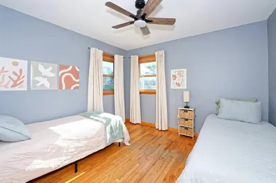 a bedroom with two beds and a ceiling fan at Five-bedroom home in Schenectady