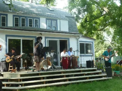 a band playing on the porch of a house at Morning Glory B n B Woodstock NY in Woodstock