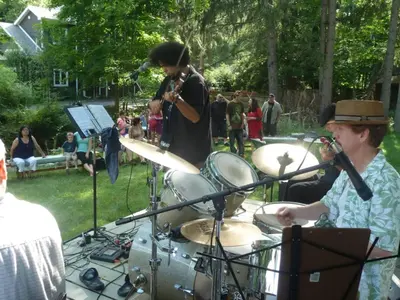 a group of people playing drums in a park at Morning Glory B n B Woodstock NY in Woodstock