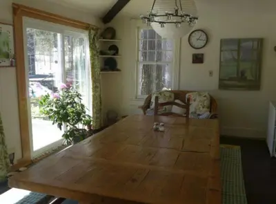 a dining room with a wooden table and a chair at Morning Glory B n B Woodstock NY in Woodstock
