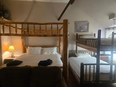 a bedroom with two bunk beds next to a lamp at Stay Saratoga in Saratoga Springs