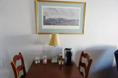 a table with a lamp and a coffee maker on it at Stay Saratoga in Saratoga Springs