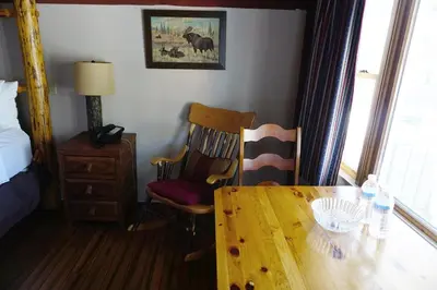 a room with a wooden table and chairs and a bed at Stay Saratoga in Saratoga Springs