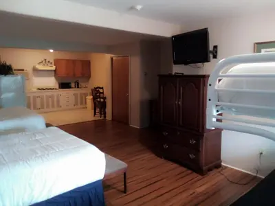 a bedroom with a bed and a flat screen tv at Stay Saratoga in Saratoga Springs