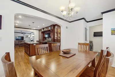 a dining room and kitchen with a wooden table and chairs at Stargazing Daydreamer in Arlington