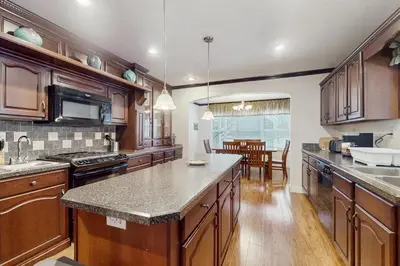 a kitchen with wooden cabinets and granite counter tops at Stargazing Daydreamer in Arlington