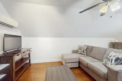 a living room with a couch and a flat screen tv at Stargazing Daydreamer in Arlington