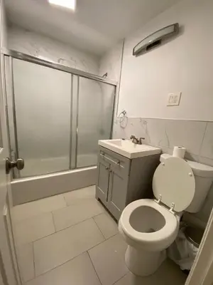 a bathroom with a shower and a toilet and a sink at C Jay Homes 6 minutes Walk to Journal square in Jersey City