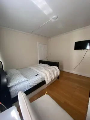 a bedroom with a bed and a flat screen tv at C Jay Homes 6 minutes Walk to Journal square in Jersey City