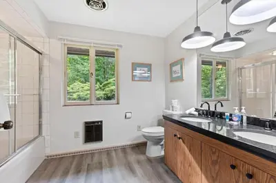 a bathroom with a sink and a toilet and a shower at Nature's Retreat 4-Bedroom Cabin in Honesdale