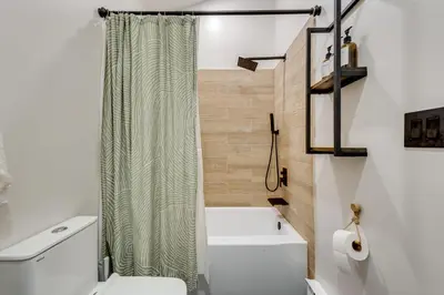 a bathroom with a shower curtain and a toilet at Lake Access at Family-Friendly Home in Tobyhanna in Tobyhanna