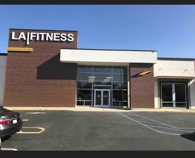 a store with a car parked in a parking lot at Haven 2 Bedroom by EWR airport in Newark