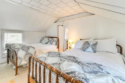 a bedroom with two beds and a balcony at Private Dock Lakefront Gem on Saratoga Lake in Saratoga Springs