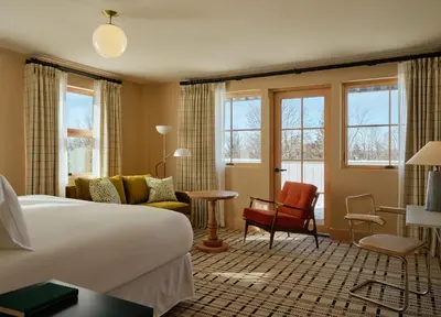 a hotel room with a bed and a living room at Belden House & Mews in Litchfield