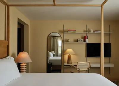 a hotel room with a bed and a mirror at Belden House & Mews in Litchfield