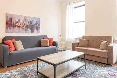 a living room with two couches and a coffee table at 5 Bedroom 2 Bath Full Floor Midtown in New York