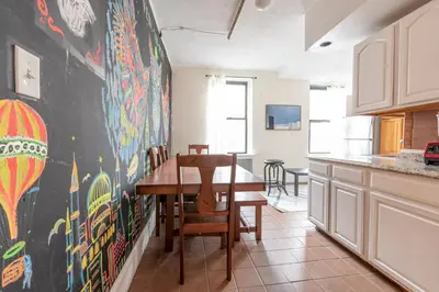 a kitchen with a table and a black wall at 5 Bedroom 2 Bath Full Floor Midtown in New York