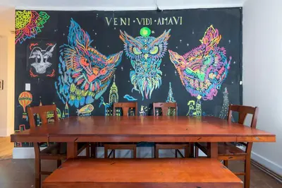 a table with chairs in front of a wall with owls at 5 Bedroom 2 Bath Full Floor Midtown in New York