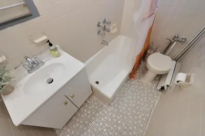 a bathroom with a white sink and a toilet at Cozy Studio Near Central Park in New York