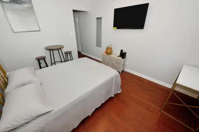 a bedroom with a bed and a flat screen tv at Cozy Studio Near Central Park in New York