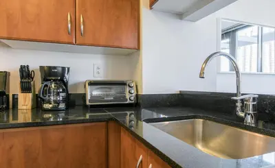 a kitchen with a sink and a microwave at Bright 2 Bedrooms 2 Bathrooms Unit in New York
