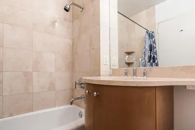 a bathroom with a sink and a tub and a shower at Bright 2 Bedrooms 2 Bathrooms Unit in New York