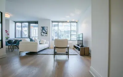 a living room with a couch and a table at Bright 2 Bedrooms 2 Bathrooms Unit in New York