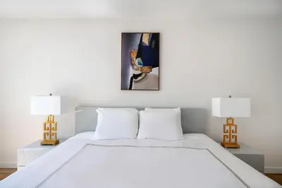 a bedroom with a white bed and two lamps at Stunning Apartment for 4 2 Bedrooms 2 Bath in New York