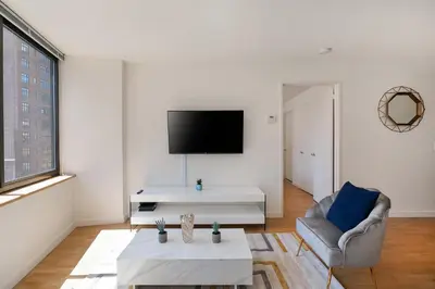 a living room with a couch and a tv at Stunning Apartment for 4 2 Bedrooms 2 Bath in New York