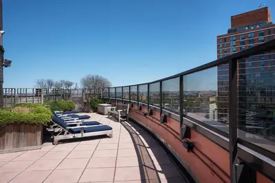 a row of lounge chairs on a balcony of a building at Stunning Apartment for 4 2 Bedrooms 2 Bath in New York