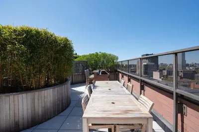 a wooden table on the roof of a building at Stunning Apartment for 4 2 Bedrooms 2 Bath in New York