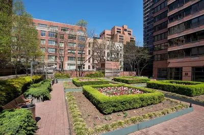a garden with flowers and bushes in a city at Stunning Apartment for 4 2 Bedrooms 2 Bath in New York