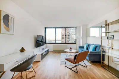 a living room with a couch and a table at Luxury 2 Bed 2 Bath Unit in Prime Location of NYC in New York