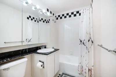 a bathroom with a sink and a toilet and a tub at Luxury 2 Bed 2 Bath Unit in Prime Location of NYC in New York